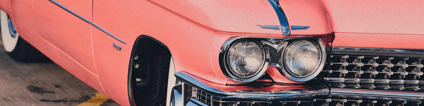 The front on a pink-colored classic car