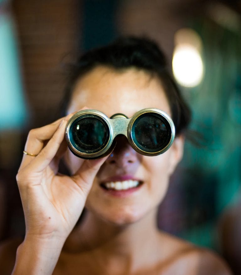 A woman holding up binoculars, zooming in on the company's privacy policy.